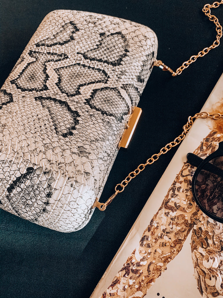 snakeskin clutch with gold detail